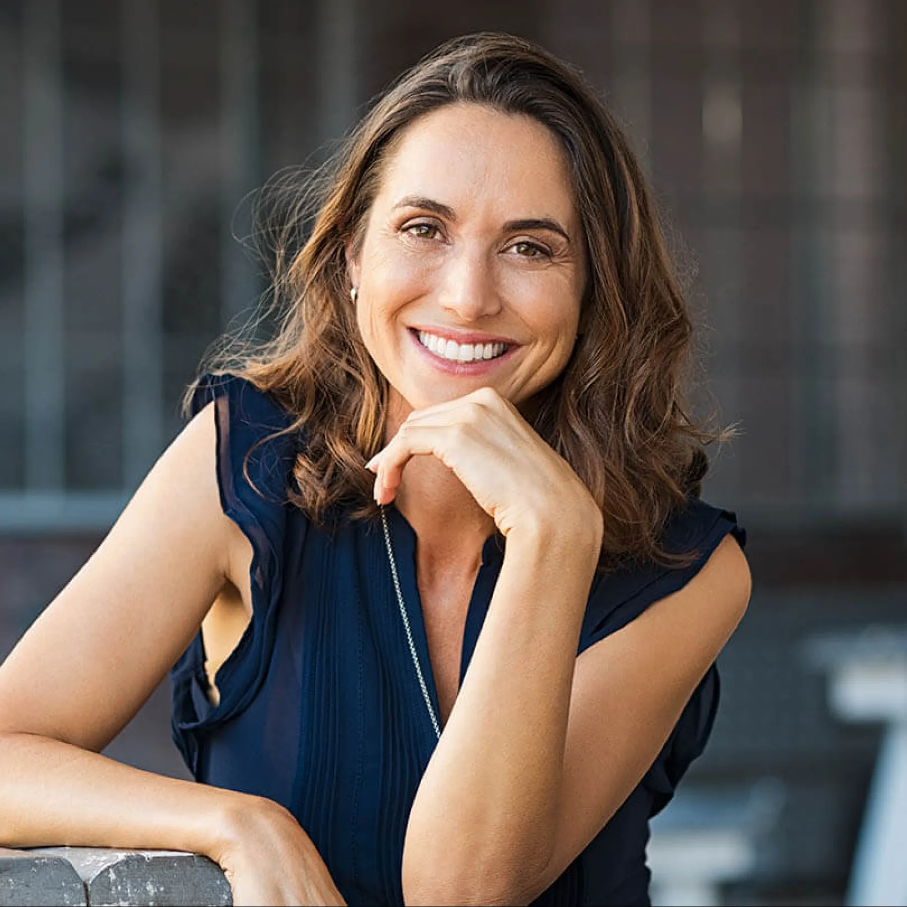 a woman with her hand on her chin