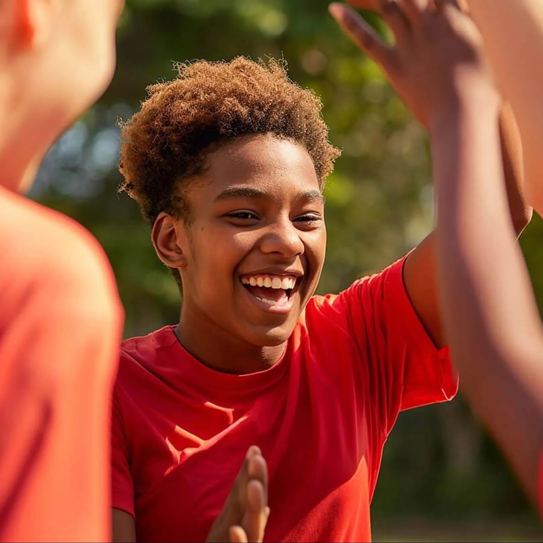 a boy with his hands up