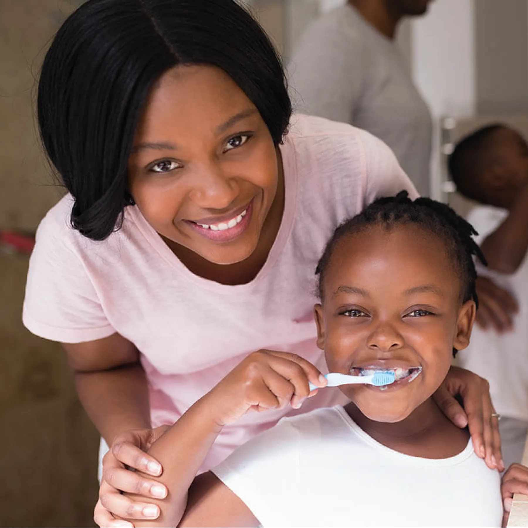 a person brushing a baby's teeth