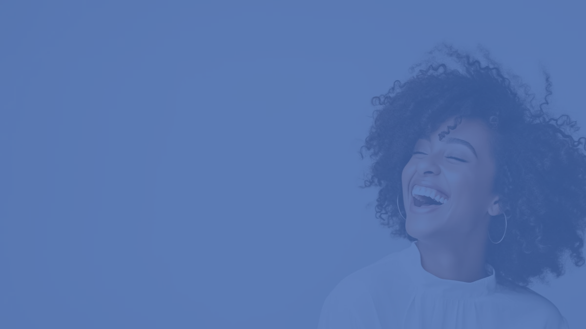 Smiling woman sitting on a sofa against a bright, minimalistic background.